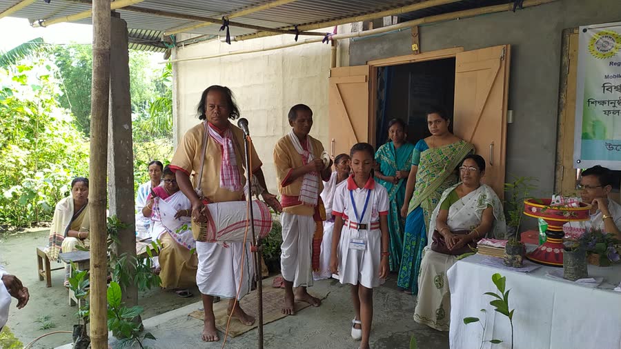 A khol player and a schoolgirl singing at a SRI SRI SANTA SAMAJ gathering