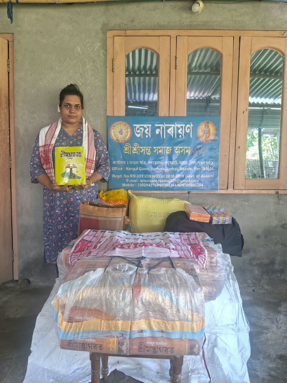 Sri Sri Santa Samaj representative with religious books and materials prepared for distribution in Nazira